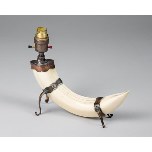 191 - AN EARLY 20TH CENTURY TAXIDERMY HIPPO TUSK LAMP.
(h 22cm x w 27cm x d 10cm)