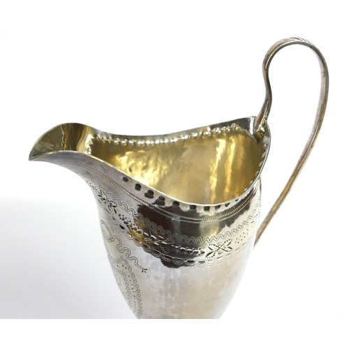 431 - A GEORGIAN SILVER CLASSICAL HELMET FORM CREAM JUG
With fine engraved decoration and square base, hal... 