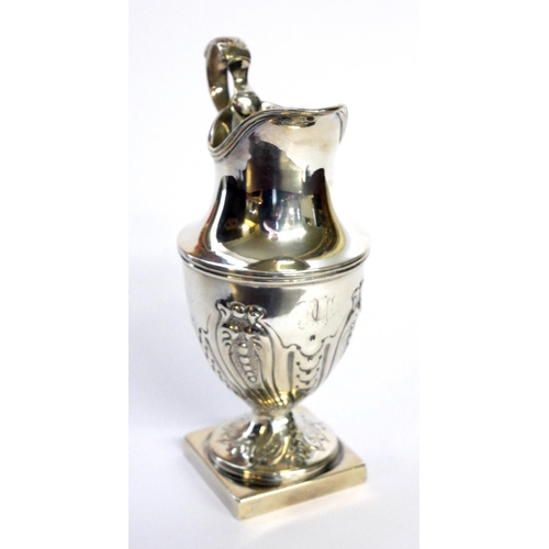 432 - A GEORGIAN SILVER CLASSICAL HELMET FORM CREAM JUG
With embossed fluted decoration, hallmarked London... 