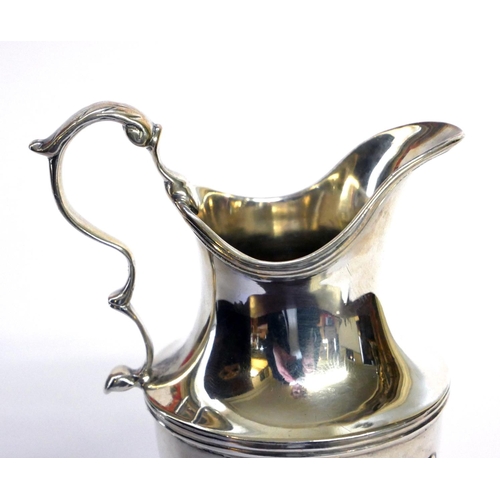 432 - A GEORGIAN SILVER CLASSICAL HELMET FORM CREAM JUG
With embossed fluted decoration, hallmarked London... 