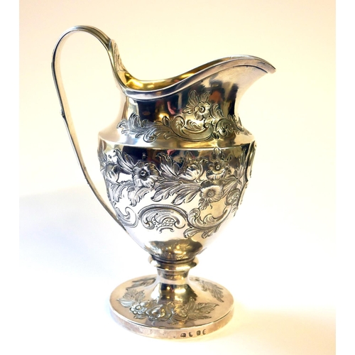 436 - A GEORGIAN SILVER CLASSICAL HELMET FORM CREAM JUG
With embossed decoration and gilt interior, hallma... 