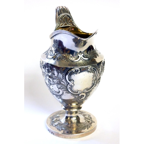 436 - A GEORGIAN SILVER CLASSICAL HELMET FORM CREAM JUG
With embossed decoration and gilt interior, hallma... 