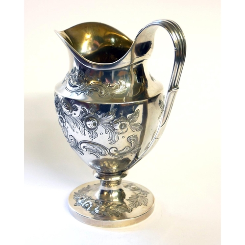 436 - A GEORGIAN SILVER CLASSICAL HELMET FORM CREAM JUG
With embossed decoration and gilt interior, hallma... 