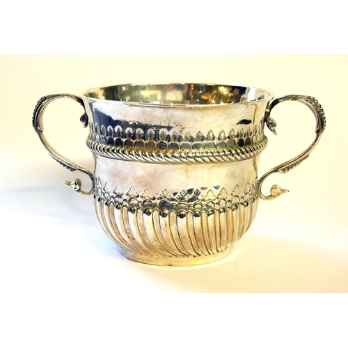 437 - A WILLIAM III SILVER PORRINGER
Twin handles and half flute decoration, hallmarked William Andrews, 1... 