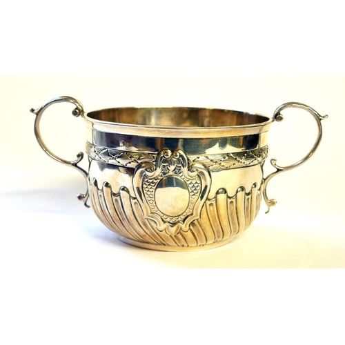 438 - A VICTORIAN SILVER PORRINGER
Twin handles and half flute decoration, hallmarked Daniel and John Well... 