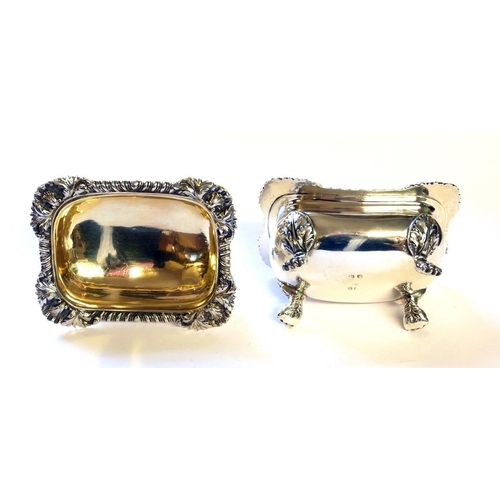 439 - A PAIR OF GEORGIAN SILVER SALTS
Having shell and gadrooned border with lion paw feet and gilt interi... 