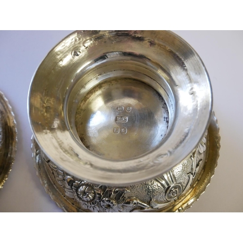 442 - A PAIR OF GEORGIAN SILVER CIRCULAR SALTS 
With embossed floral decoration and flared foot rim, hallm... 