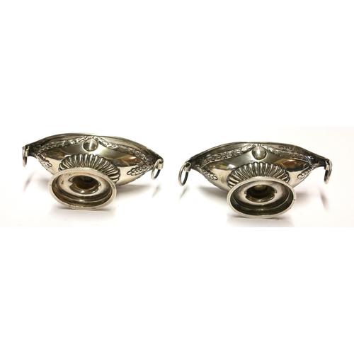 447 - A PAIR OF VICTORIAN SILVER CLASSICAL NAVETTE FORM SALTS
With ring handles and embossed decoration, h... 