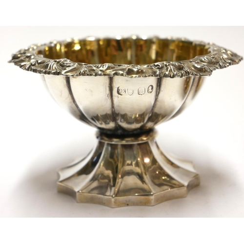 451 - A PAIR OF GEORGIAN SILVER CIRCULAR SALTS 
With scrolled border, gilt interior and fluted base, hallm... 