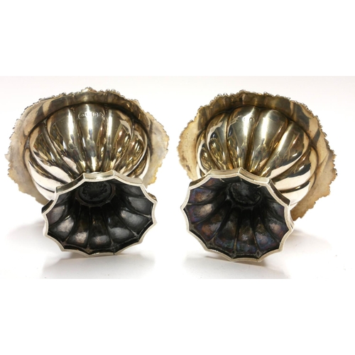 451 - A PAIR OF GEORGIAN SILVER CIRCULAR SALTS 
With scrolled border, gilt interior and fluted base, hallm... 