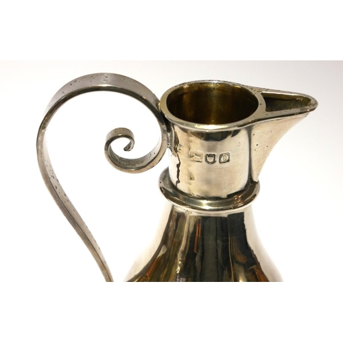 453 - A VICTORIAN ECCLESIASTICAL SILVER BALUSTER FORM JUG 
With scrolled handle and fluted foot rim, inscr... 