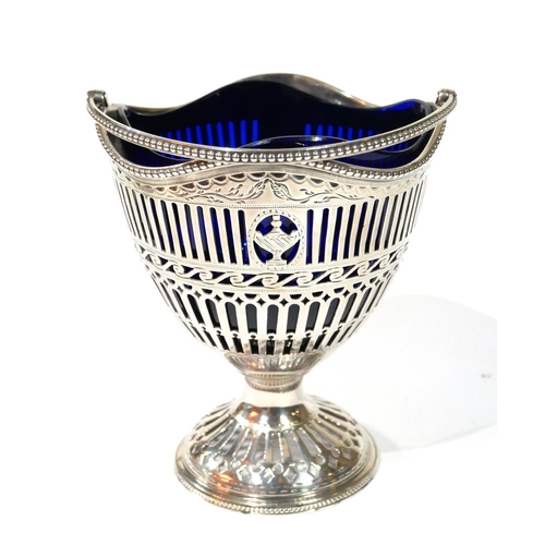 458 - A GEORGIAN SILVER AND BLUE GLASS SWEETMEAT BASKET
Classical form with swing handle and pierced decor... 