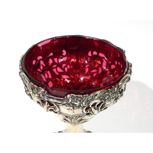 461 - A VICTORIAN SILVER AND CRANBERRY GLASS SWEETMEAT TAZZA
Having pierced as scrolled decoration and gla... 