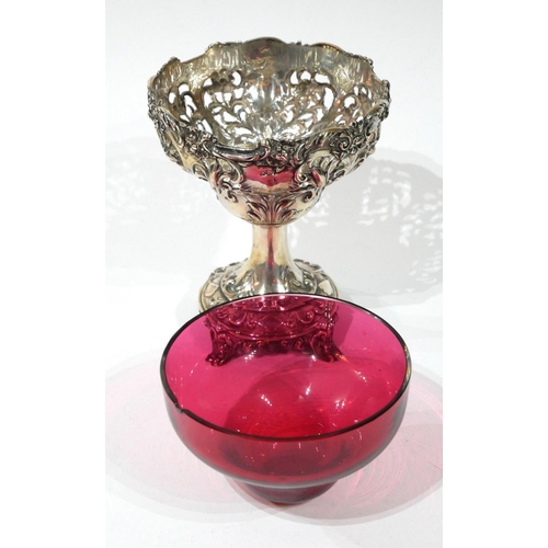 461 - A VICTORIAN SILVER AND CRANBERRY GLASS SWEETMEAT TAZZA
Having pierced as scrolled decoration and gla... 