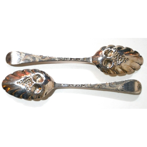 474 - A PAIR OF GEORGIAN SILVER BERRY SPOONS
Having engraved armorial crest to finial and gilt embossed de... 