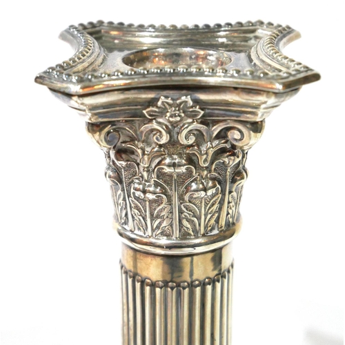 515 - A PAIR OF EDWARDIAN SILVER CANDLESTICKS
Classical firm with reeded columns, hallmarked 'J. Sherwood ... 