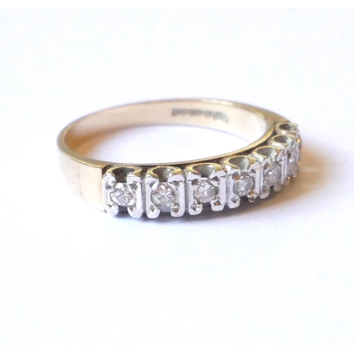 548 - A VINTAGE 9CT GOLD AND DIAMOND HALF ETERNITY RING
The arrangement of seven round cut diamonds.
(appr... 