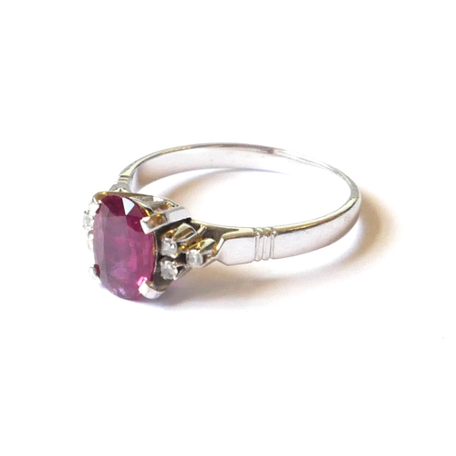 550 - A VINTAGE 14CT WHITE GOLD AND RUBY AND DIAMOND RING
Having an oval cut stone flanked by diamonds (si... 