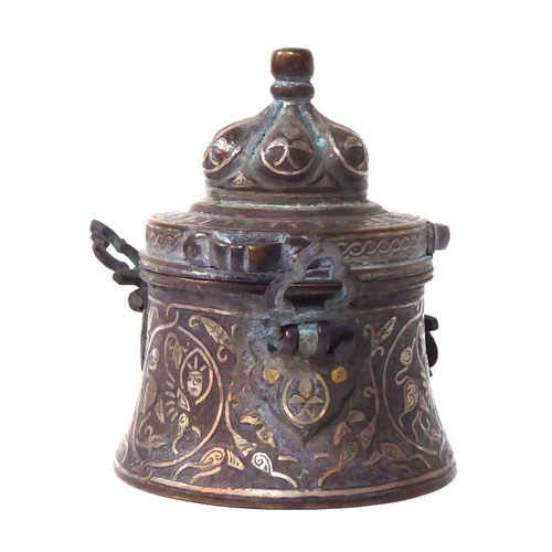 571 - AN ANTIQUE PERSIAN BRONZE AND SILVER CEREMONIAL VESSEL
Having a done form lid and silver wire decora... 