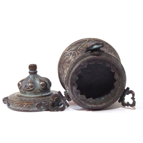 571 - AN ANTIQUE PERSIAN BRONZE AND SILVER CEREMONIAL VESSEL
Having a done form lid and silver wire decora... 