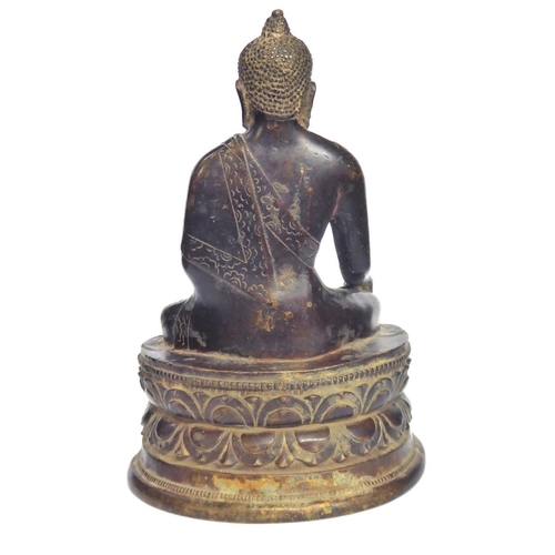 572 - A CHINESE BRONZE BUDDHA
Seated pose with ceremonial vessel and double lotus base 
Bearing a label to... 