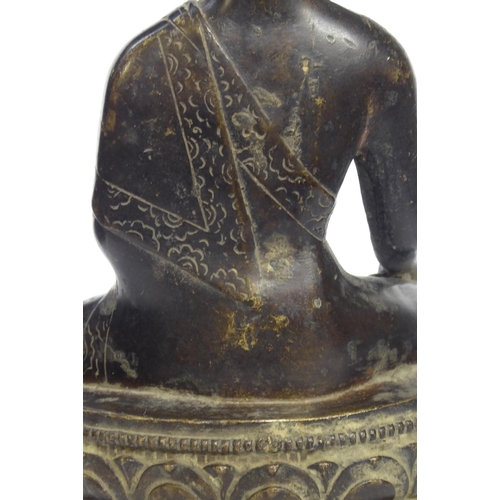 572 - A CHINESE BRONZE BUDDHA
Seated pose with ceremonial vessel and double lotus base 
Bearing a label to... 