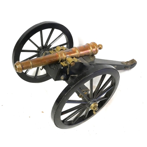 573 - A LATE 19TH/EARLY 20TH CENTURY BRONZE CANNON WITH FIELD CARRIAGE.
(98cm x 57cm x 41cm)