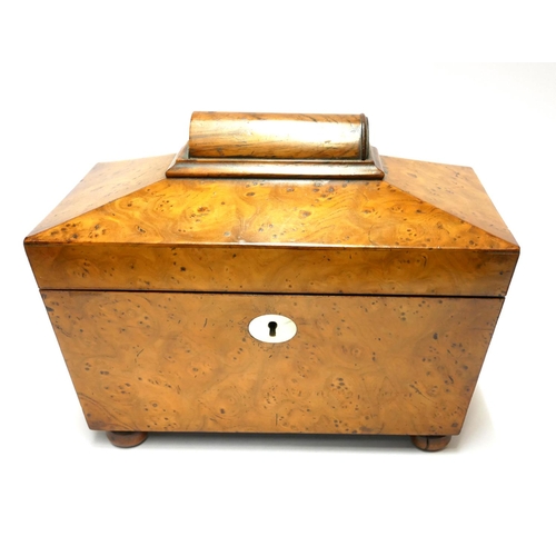 579 - A 19TH CENTURY BURR WOOD TEA CADDY
Sarcophagus form with oval mother pearl escutcheon and bun feet.