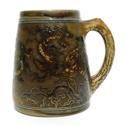 587 - MARTIN BROTHERS, BRITISH, ESTABLISHED 1873, A STONEWARE GLAZED TANKARD
The incised decoration in the... 