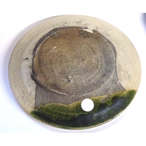 606 - A JAPANESE ORIBE POTTERY PLATE
Having a shallow rim and hand painted decoration.
(approx 22cm)