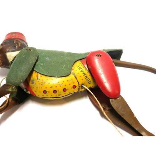 609 - AN EARLY 20TH CENTURY GERMAN TINPLATE CLIMBING MONKEY TOY
Wearing a red fez hat and green jacket.
(a... 