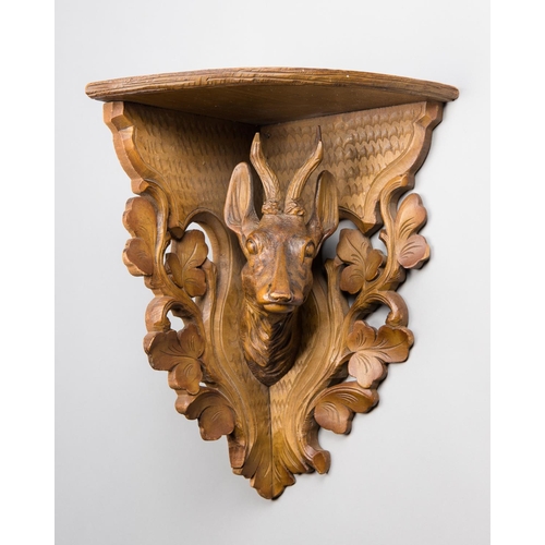 247 - AN EARLY 20TH CENTURY BLACK FOREST CARVED FRUITWOOD BRACKET SHELF.