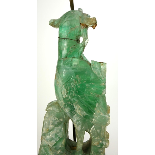 725 - A CHINESE GREEN QUARTZ TABLE LAMP 
Carved as a Phoenix on hardwood stand.
(55cm)

Condition: good th... 