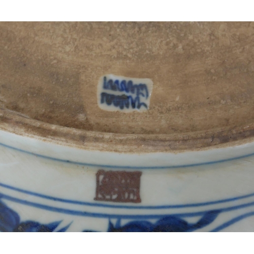 726 - A LARGE CHINESE BLUE AND WHITE SHALLOW BOWL 
With cartouche border, decorated with clouds and floral... 