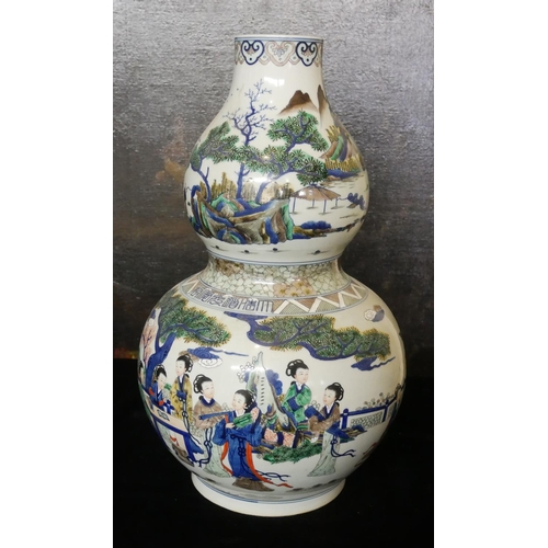 729 - A LARGE CHINESE DOUBLE GOURD VASE 
Famille verte decoration, in the form of maidens in garden settin... 