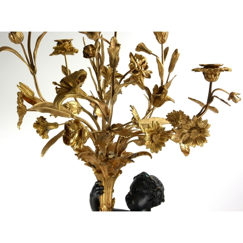740 - A LARGE PAIR OF GILT AND PATINATED BRONZE SIX SCONCE CANDELABRA IN THE FORM OF PUTTI
Holding foliage... 