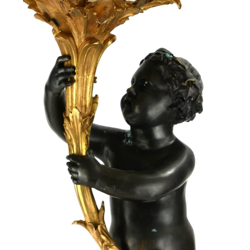 740 - A LARGE PAIR OF GILT AND PATINATED BRONZE SIX SCONCE CANDELABRA IN THE FORM OF PUTTI
Holding foliage... 