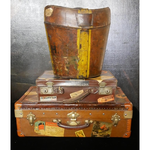 748 - A VINTAGE LEATHER HAT BOX
Along with two suit vases, bearing numerous labels.