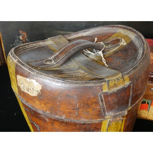 748 - A VINTAGE LEATHER HAT BOX
Along with two suit vases, bearing numerous labels.