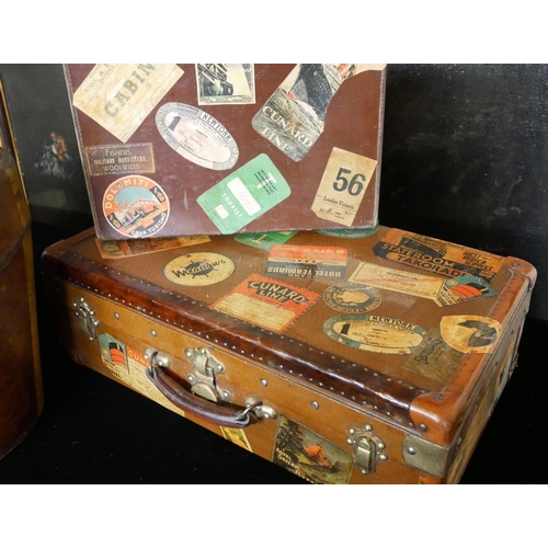 748 - A VINTAGE LEATHER HAT BOX
Along with two suit vases, bearing numerous labels.