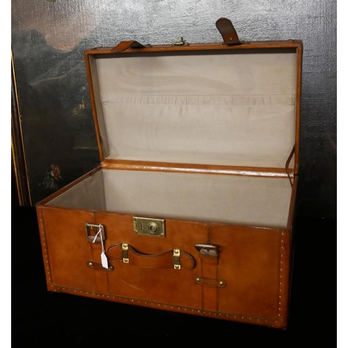 758 - A TAN LEATHER TRUNK
Applied with straps and brass fittings.
(65cm x 35.5cm x 31cm)

Condition: good ... 