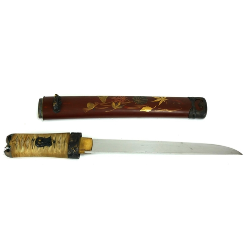 766 - A JAPANESE TANTO DAGGER
Having a shark skin handle set with gilt bronze fuchi and mounts, the dark r... 