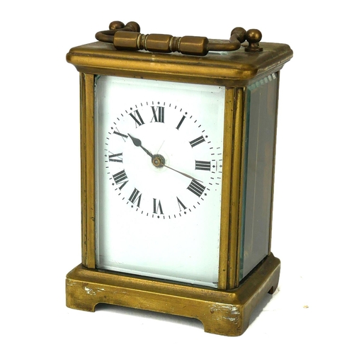 780 - AN EARLY 20TH CENTURY GILT BRASS CARRIAGE CLOCK
Having a brass carry handle, rectangular white dial ... 