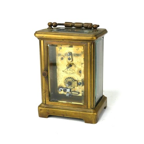 780 - AN EARLY 20TH CENTURY GILT BRASS CARRIAGE CLOCK
Having a brass carry handle, rectangular white dial ... 
