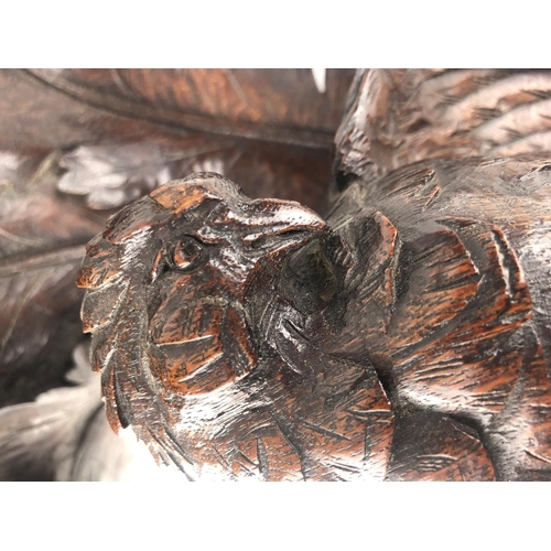 806 - A 19TH CENTURY SWISS CARVED OAK WALL BRACKET
Finely carved with a bird of prey, beneath scrolling oa... 