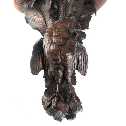 806 - A 19TH CENTURY SWISS CARVED OAK WALL BRACKET
Finely carved with a bird of prey, beneath scrolling oa... 