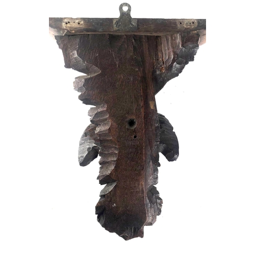 806 - A 19TH CENTURY SWISS CARVED OAK WALL BRACKET
Finely carved with a bird of prey, beneath scrolling oa... 