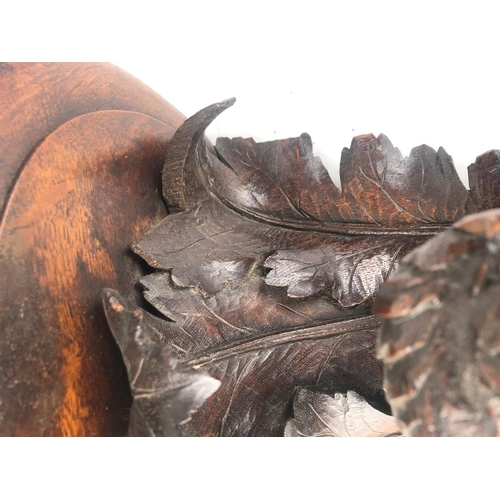 806 - A 19TH CENTURY SWISS CARVED OAK WALL BRACKET
Finely carved with a bird of prey, beneath scrolling oa... 