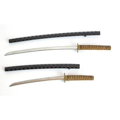 250 - A PAIR OF JAPANESE MINIATURE SAMURAI SWORDS
Having shagreen handles and black lacquer scabbards, in ... 