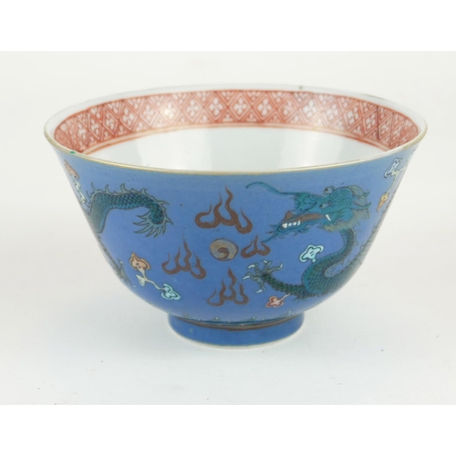 253 - A JAPANESE BLUE GLAZE PORCELAIN 'DRAGON' CUP
Having green enamel decoration of dragons chasing a fla... 